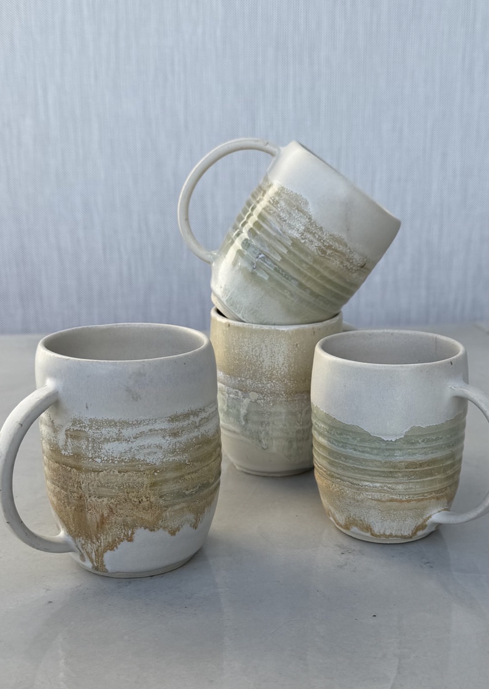 Stoneware mugs with layered mineral glaze